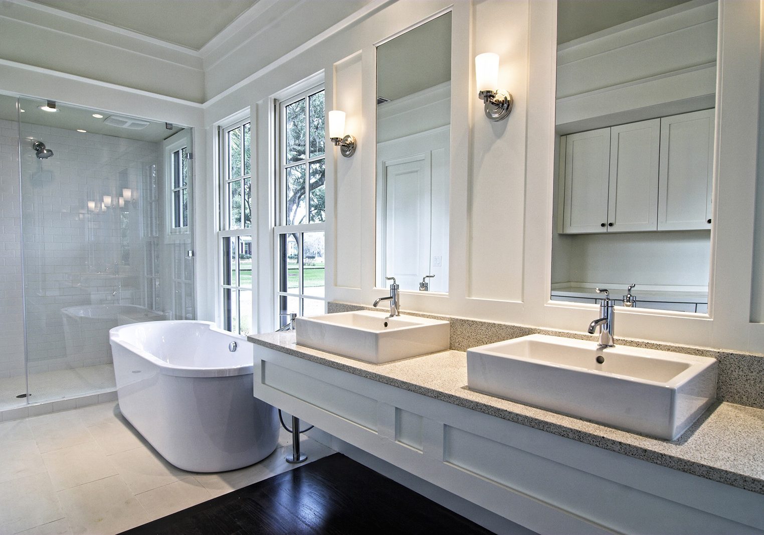 modern spacious white bathroom with dark wood floors