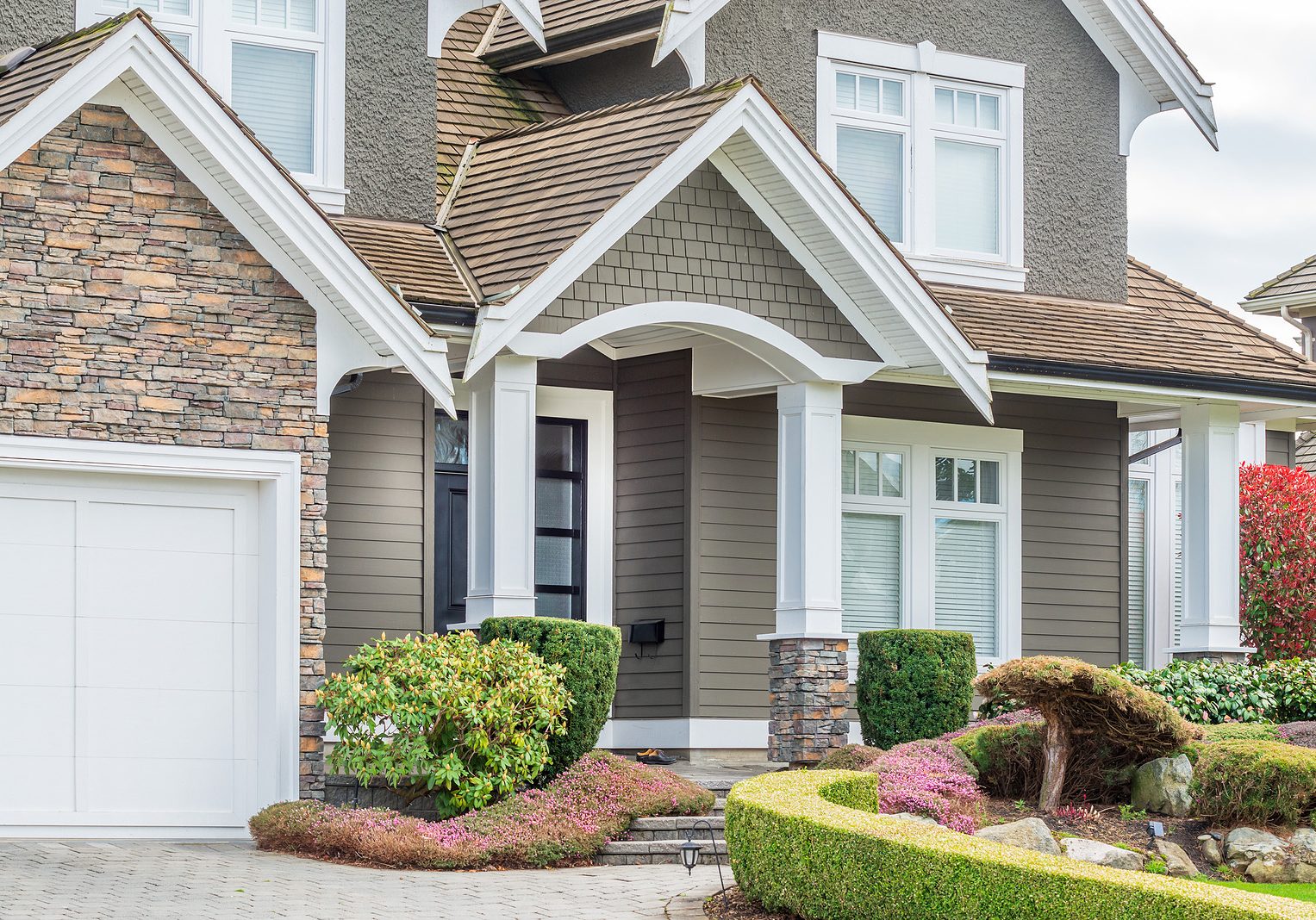 A perfect neighborhood. Houses in suburb at Spring in the north A perfect neighborhood. Houses in suburb at Spring in the north America. Fragment of a luxury house with entrance door and nice window.